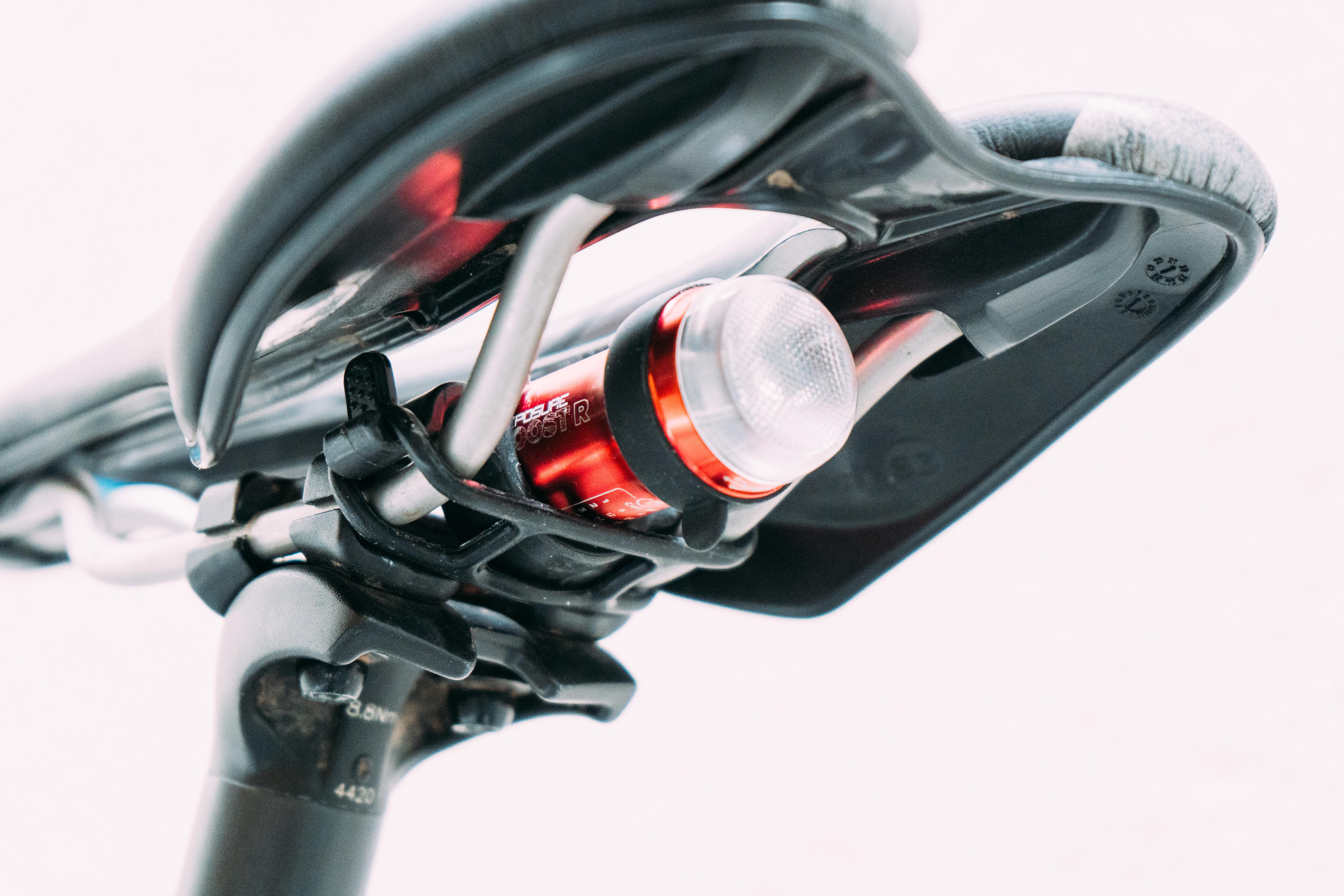 A red bike light mounted under a bike saddle