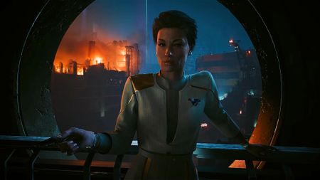 A character from Cyberpunk 2077's upcoming Phantom Liberty expansions stands in front of a field of wreckage