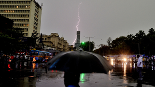 Lightning strikes above a busy street in Kolkata