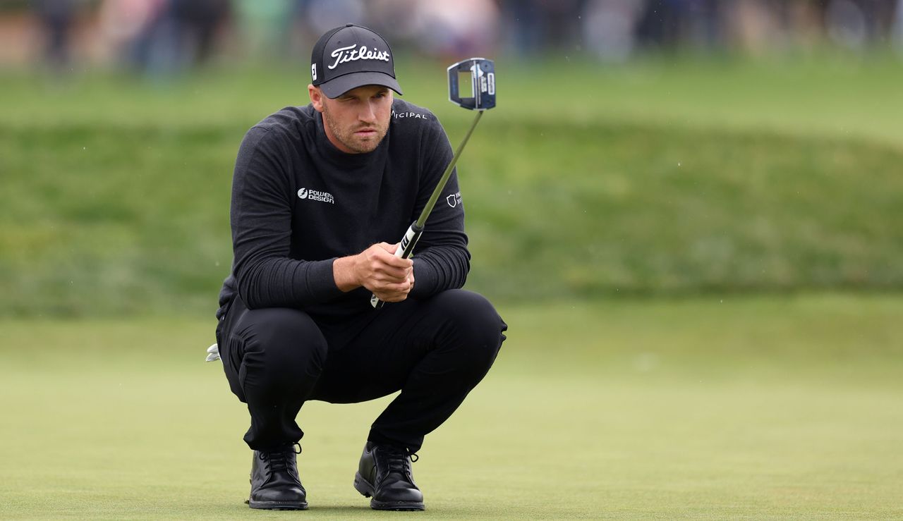 Wyndham Clark lines up a putt on the green at Pebble Beach