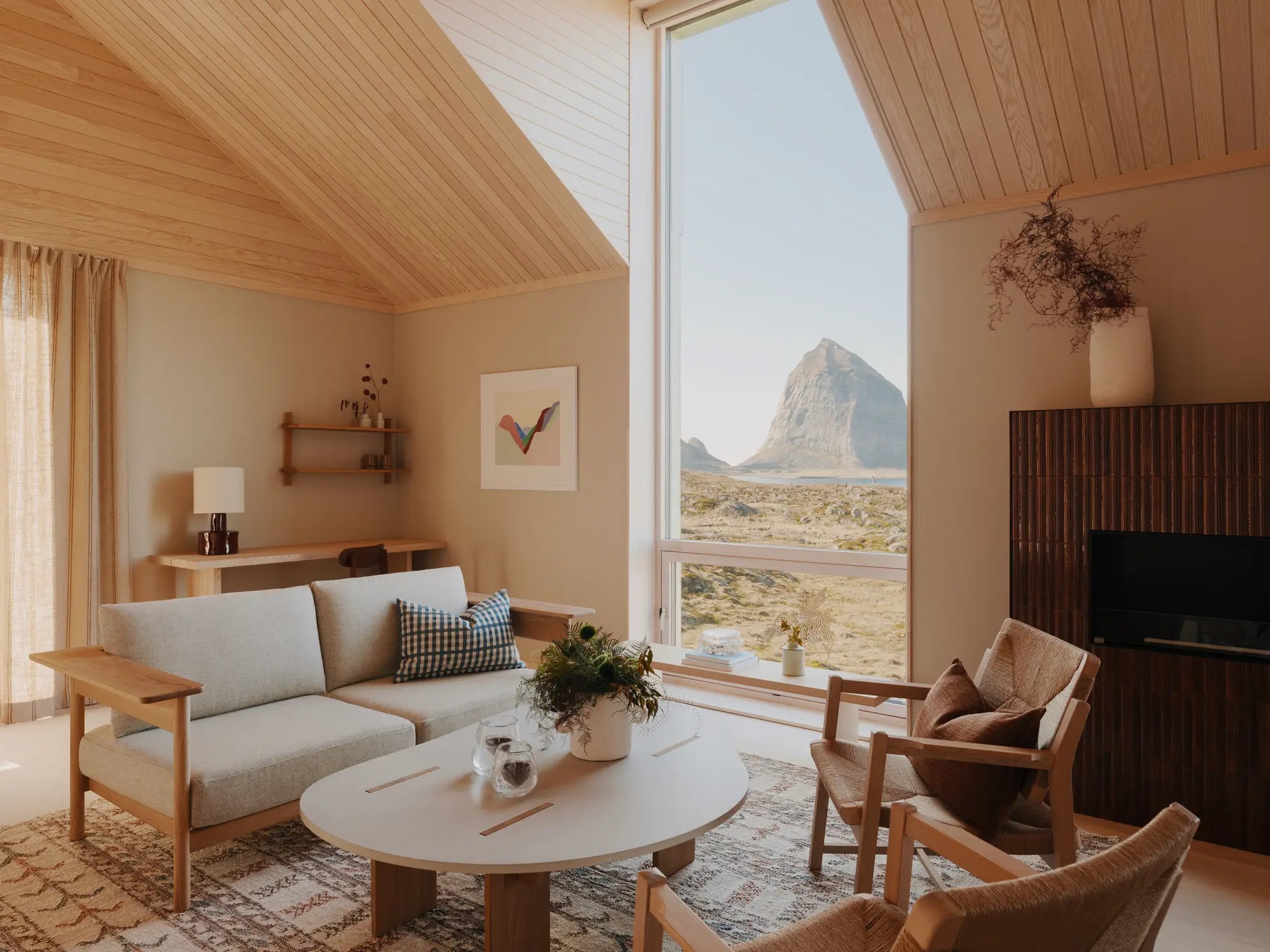 A pale wood retreat with neutral-tinted furnishings, plenty of natural light, and floor-to-ceiling windows letting nature inside.