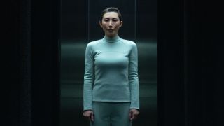 Gemma in light blue wardrobe standing in Testing Floor elevator in Severance Season 2 "Chikhai Bardo"