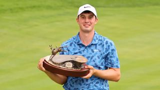 Davis Thompson holds the 2024 John Deere Classic trophy