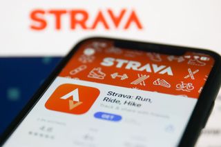 Orange and white Strava app on mobile phone