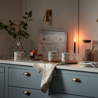 blue kitchen drawers with cup handles and Christmas mugs