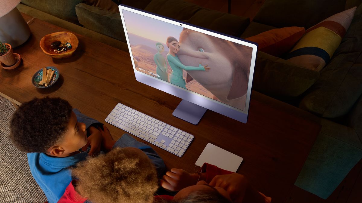 Two children looking at the iMac M4 