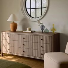 Cream accent chair and wooden sideboard unit