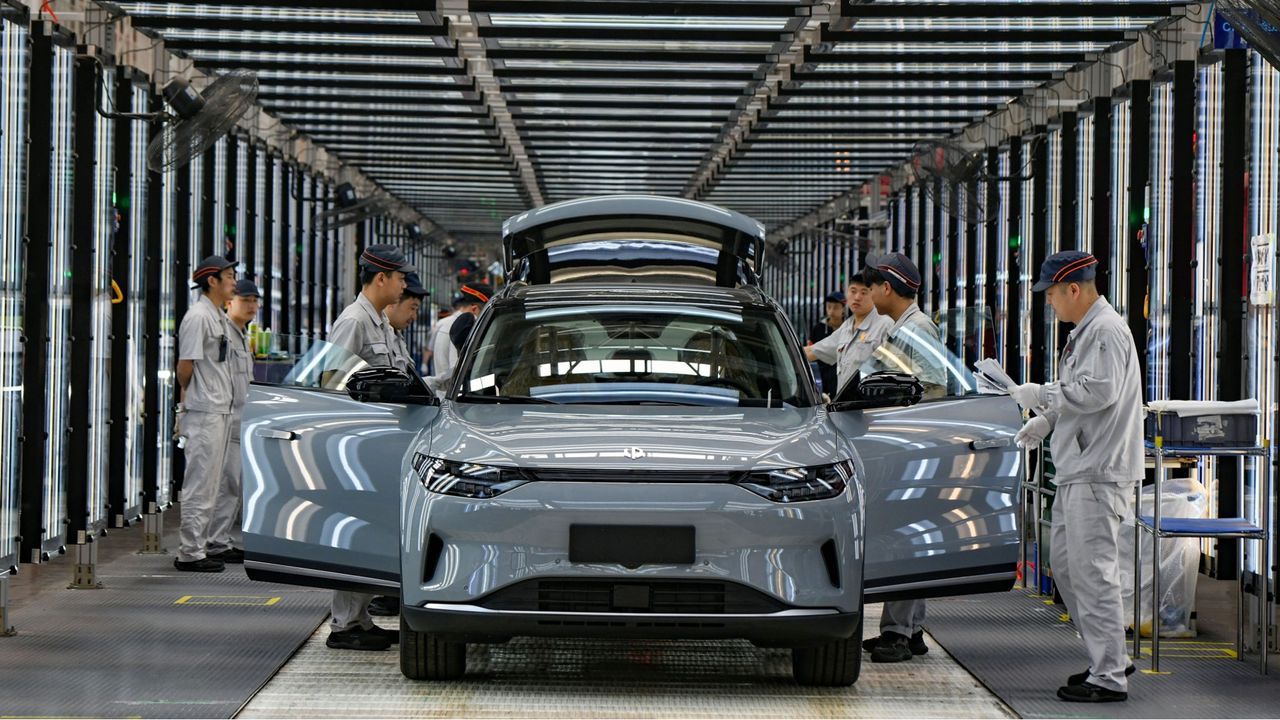 Employees work on the assembly line of new energy vehicles at a factory of Chinese EV startup Leapmotor