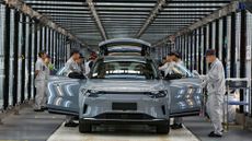 Employees work on the assembly line of new energy vehicles at a factory of Chinese EV startup Leapmotor