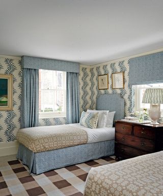blue and brown patterned twin bedroom with fern wallpaper