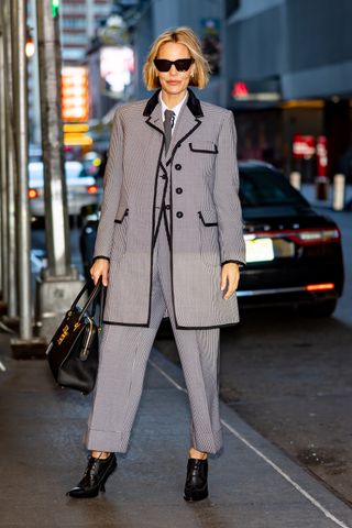 Leslie Bibb in a Thom Browne three-piece houndstooth suit and tie in New York