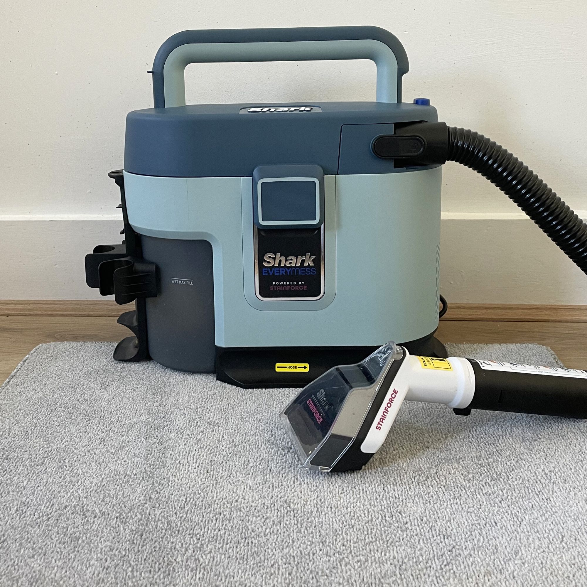 Shark EveryMess sitting on a grey carpet sample