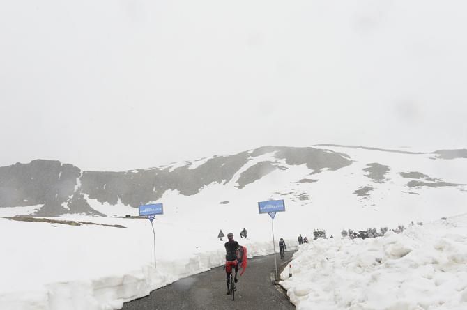 Riders bundle up on their way over the Gavia pass