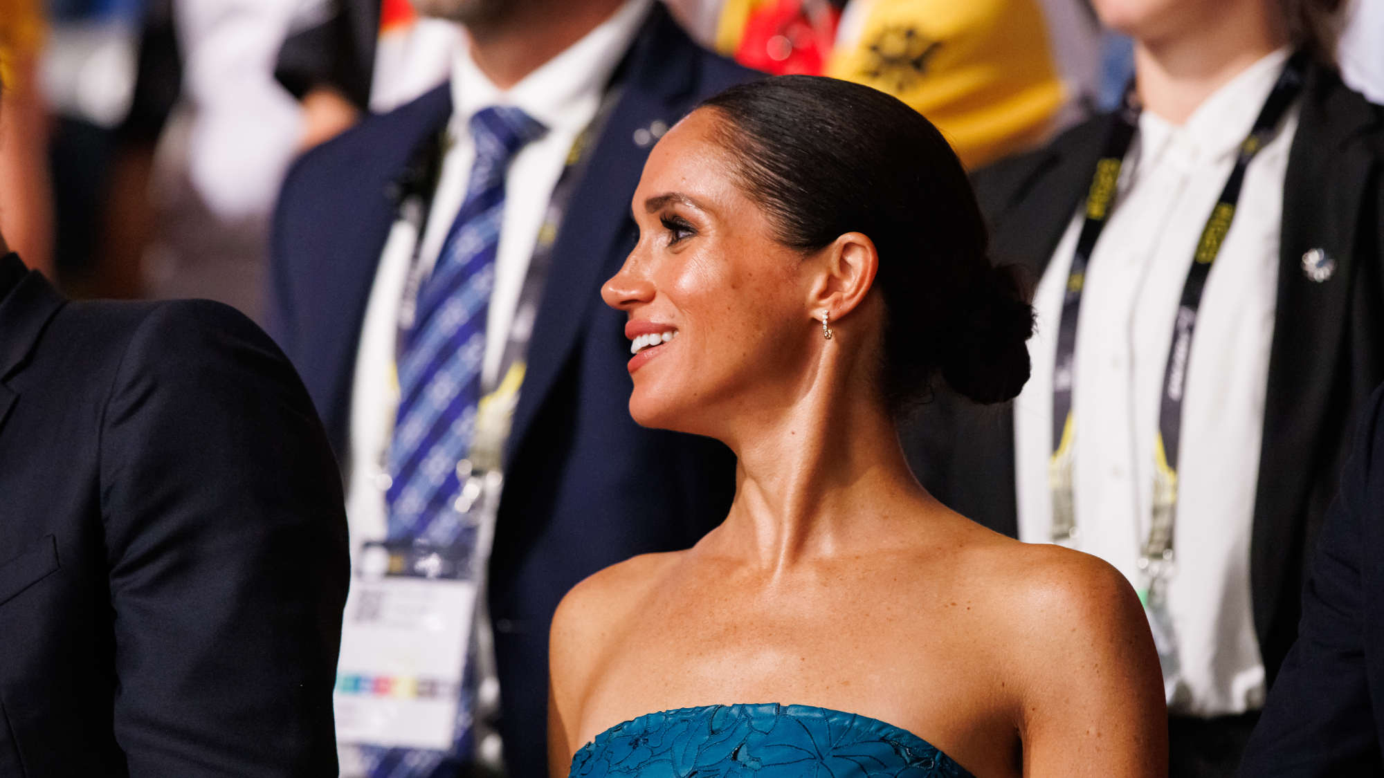 Side profile of Meghan Markle low sleek bun hairstyle at the nape of her neck