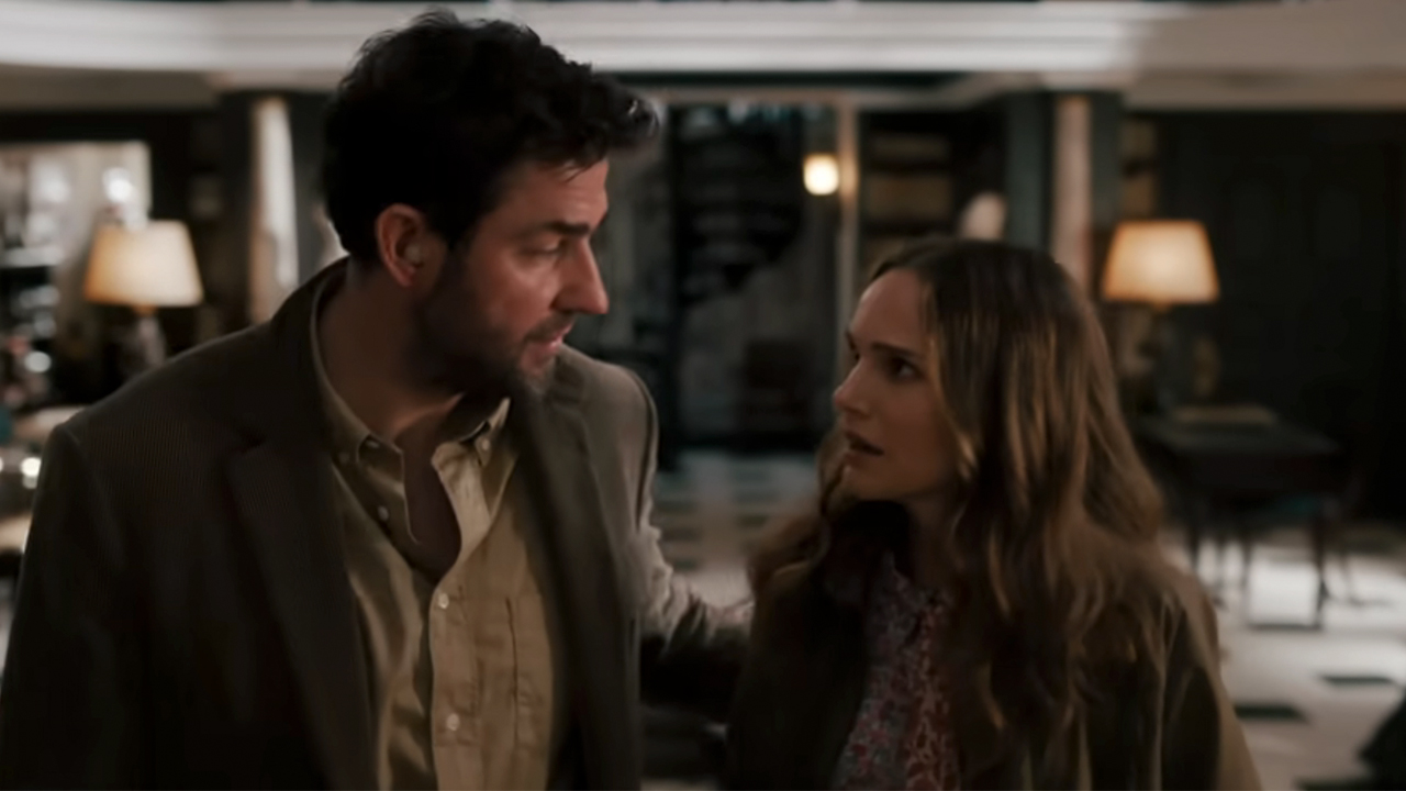 John Krasinski on the left, talking to Natalie Portman in Fountain Of Youth