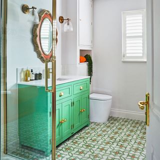 Green cabinets in colourful kitchen