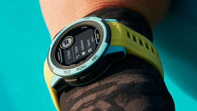 Women&#039;s wrist wearing Garmin Instinct 2S Surf Edition