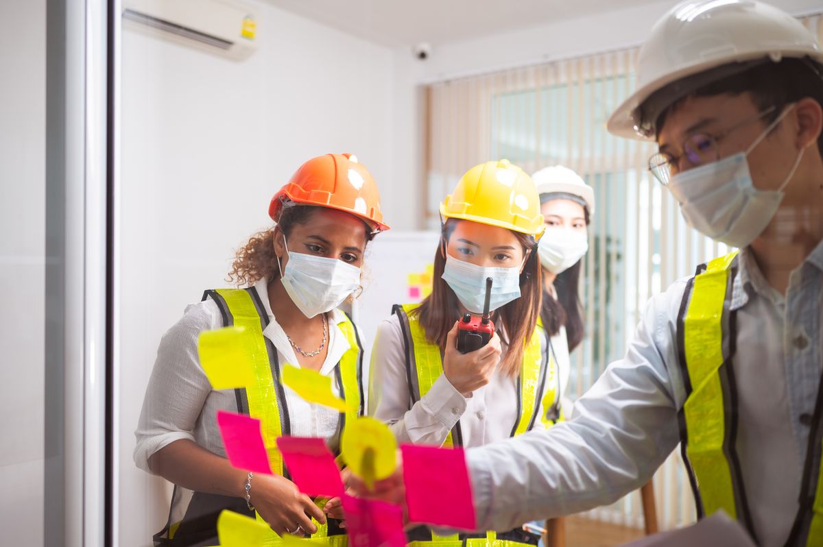 Multi-ethnic coworkers brainstorming in office. teamwork and meeting concept of foreman architecture designer and construction engineering cooperation