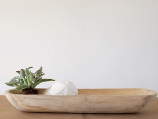 wooden decorative bowl with trinkets inside