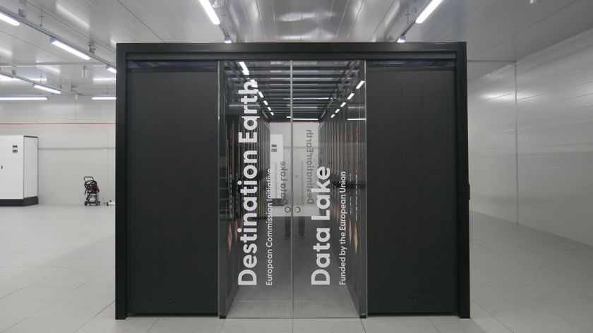 A photo of a computing cabinet within the LUMI supercomputer in Kajaani, Finland. The black cabinet bears the words &quot;Destination Earth, European Commission Initiative, Data Lake, Funded by the European Union&quot; and is situated within a clinical white room.