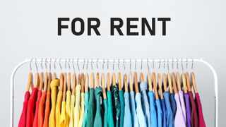 Rack with bright clothes for rent on light background