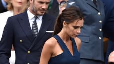 victoria beckham wearing a navy dress