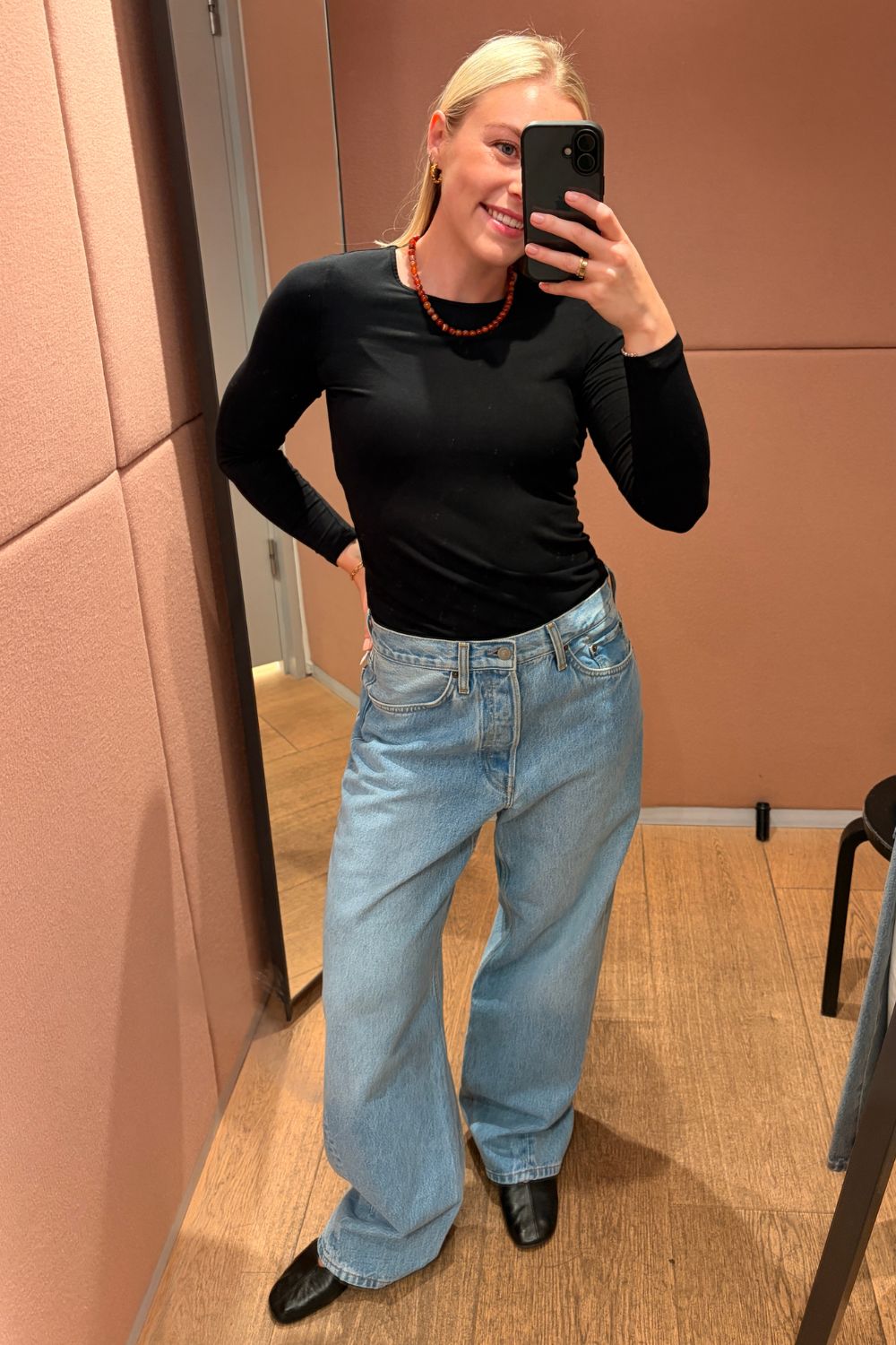 Shopping editor, Florrie, wears the COS Facade straight-leg jeans, black top, black ballet flats and red bead necklace