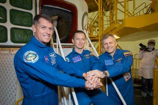 NASA astronaut Shane Kimbrough and Russian cosmonauts Sergey Ryzhikov and Andrey Borisenko posed in front of the Soyuz MS-02 spacecraft on Oct. 13, 2016, less than a week before their Oct. 19 launch to the International Space Station on that spacecraft.