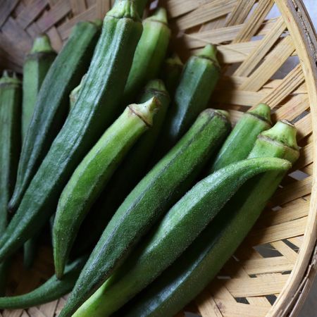 Fresh okra pods in a basket