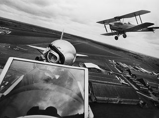 Tiger Moth aircraft fly over the former RAF Flying Training School at Sywell, UK.