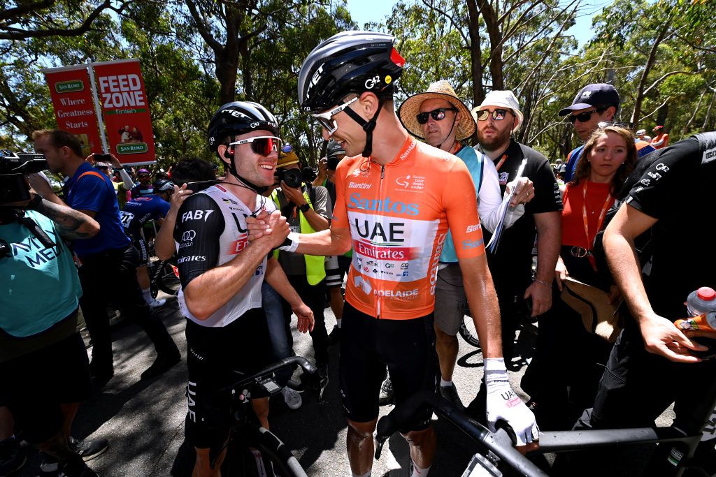 MOUNT LOFTY AUSTRALIA JANUARY 22 LR Marc Hirschi of Switzerland and Jay Vine of Australia and UAE Team Emirates Orange Leader Jersey celebrate the victory during the 23rd Santos Tour Down Under 2023 Stage 5 a 1125km stage from Unley to Mount Lofty 727m TourDownUnder WorldTour on January 22 2023 in Mount Lofty Australia Photo by Tim de WaeleGetty Images