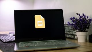 Google Slides logo on a laptop screen