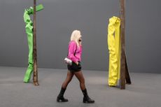 woman walking amongst sculptures