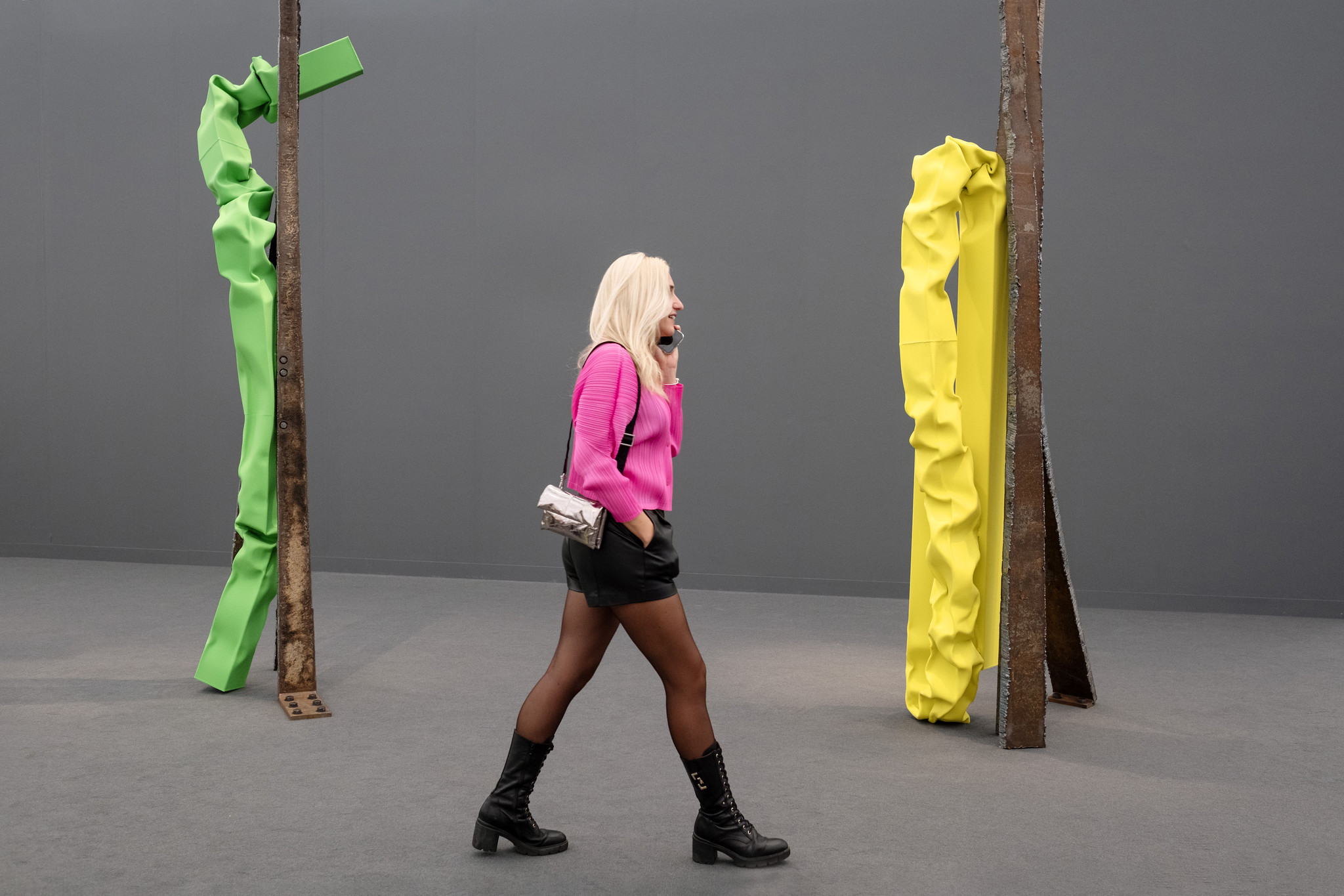 woman walking amongst sculptures