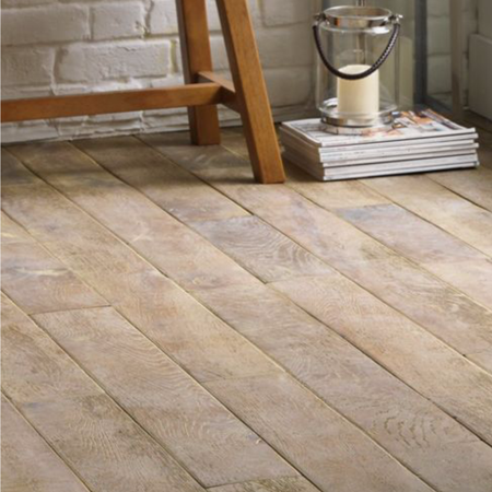 Schrieber Dusk Real Wood Flooring with a candle in a jar resting on magazines at the top of the image along with the base of wooden furniture