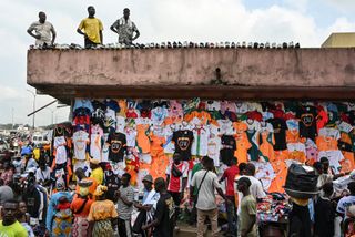 Vendors sell football kits belonging to different clubs and national teams at a market stall ahead of the 2024 Africa Cup of Nations in Abidjan on January 6, 2024. Ivory Coast is getting ready to host the 34th Africa Cup of Nations, which begins on January 13, 2024, bringing joy to the numerous football fans known for their enthusiasm in the West African country that has been awaiting the event for 40 years.