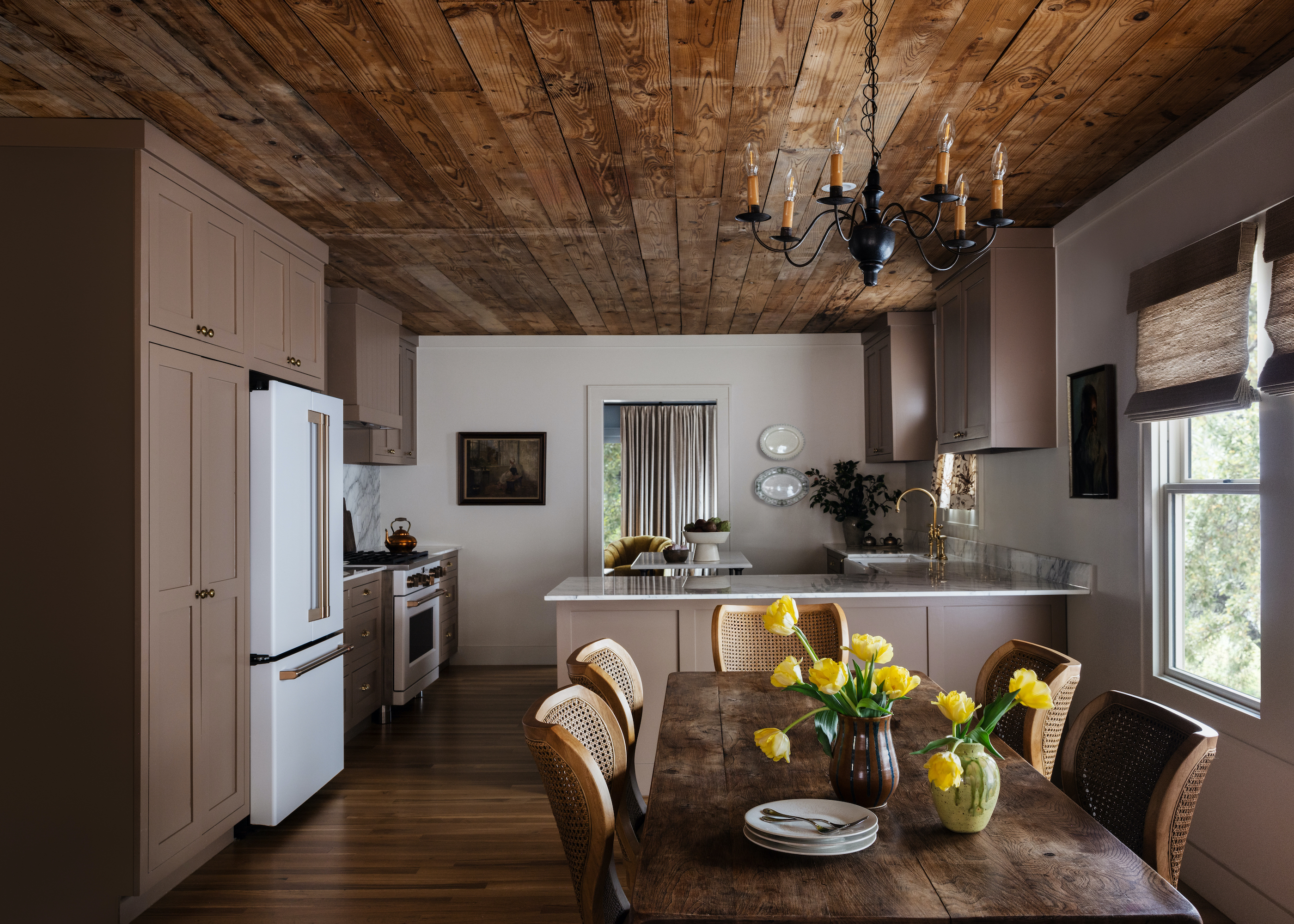 brown kitchen with timber ceiling, a wood dining table with six seats, and a chandelier from the ceiling
