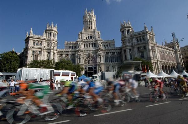 Riders are a blur in front of historic scenery