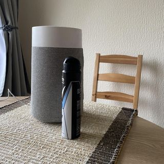 Blueair Blue Pure Mini Max Air Purifier on table next to aerosol deodorant