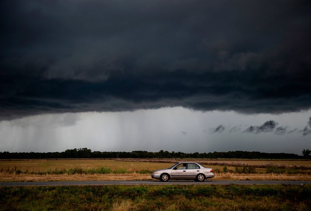 A car drives down a road near Lake Charles, Louisiana.