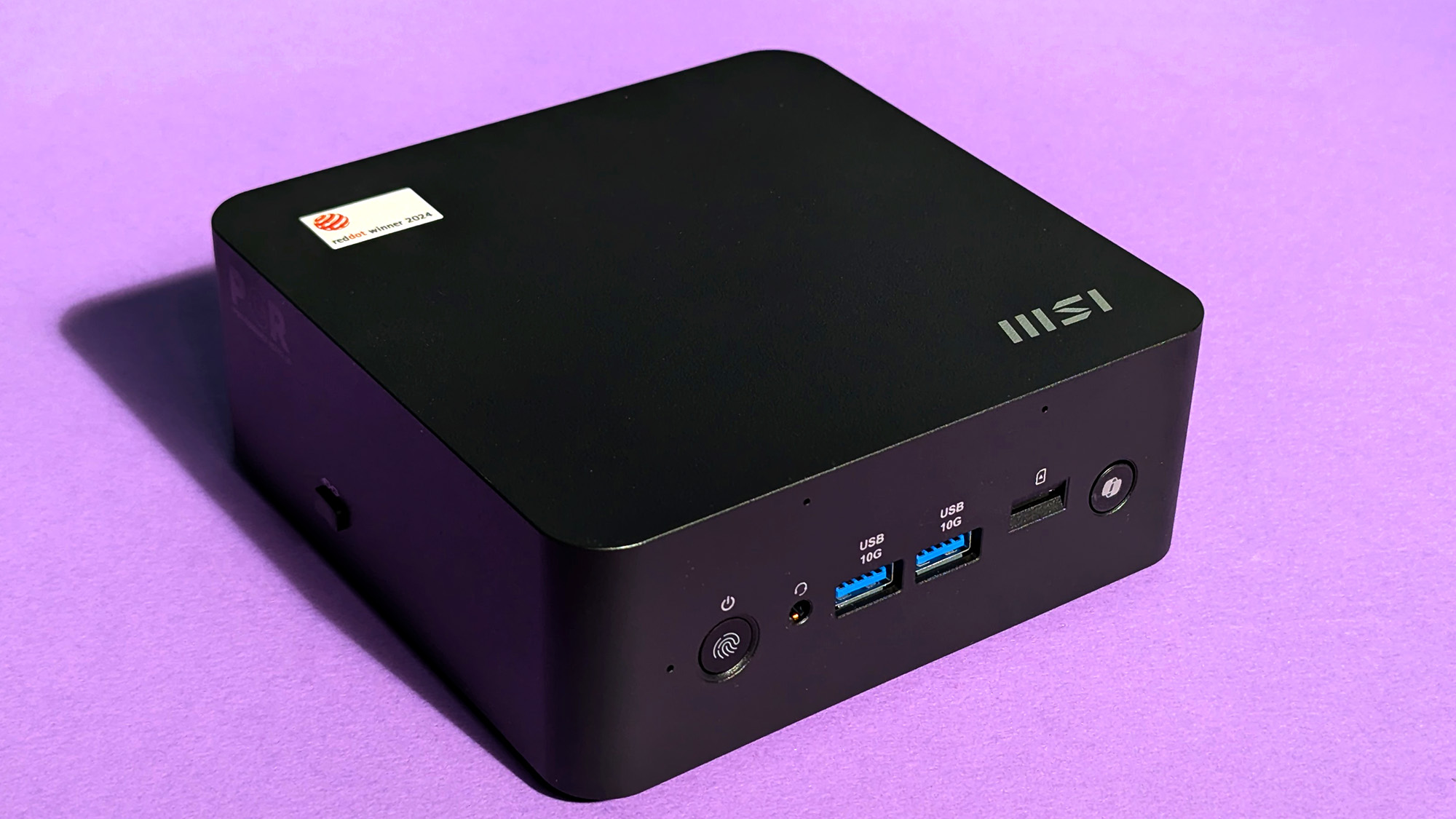 MSI Cubi NUC AI+ 2MG mini PC on a purple card stock background