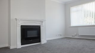 gas fireplace in white chimney breast