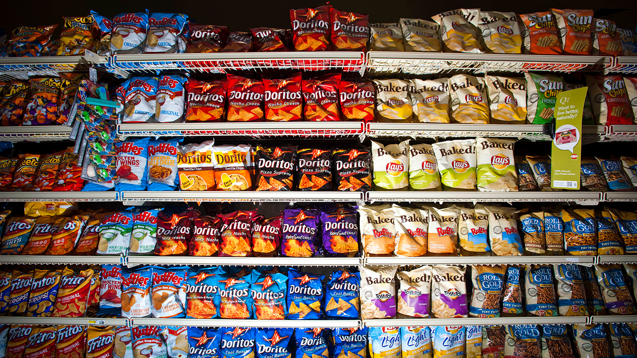 Packets of crisps on a supermarket shelf