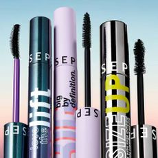 A variety of Sephora mascaras on an blue and pink ombre background.