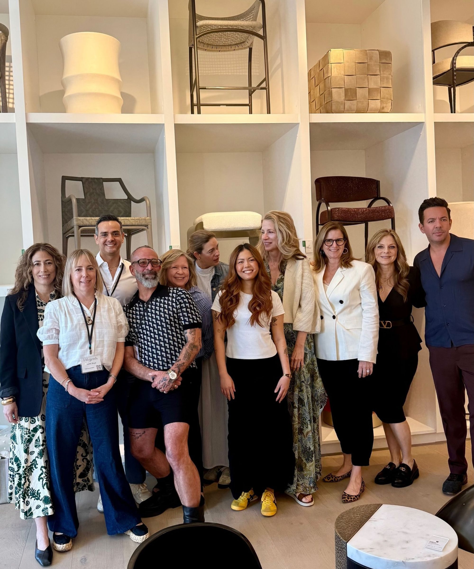 Group of people standing in a furniture showroom posing for a photograph