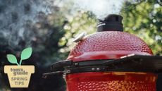 kamado joe grill with smoke coming out of the top