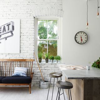 white plain and brick wall window marble counter tables and wooden seat with cushion