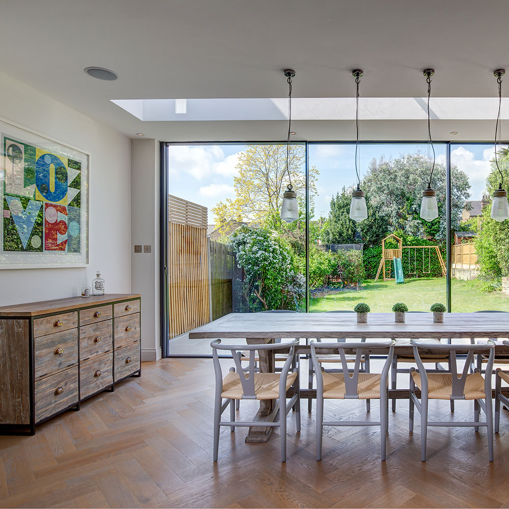 Victorian home with a spacious glass extension, dining table and garden