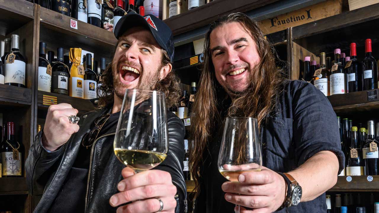 Joel and Ryan O'Keefe raise their wine glasses