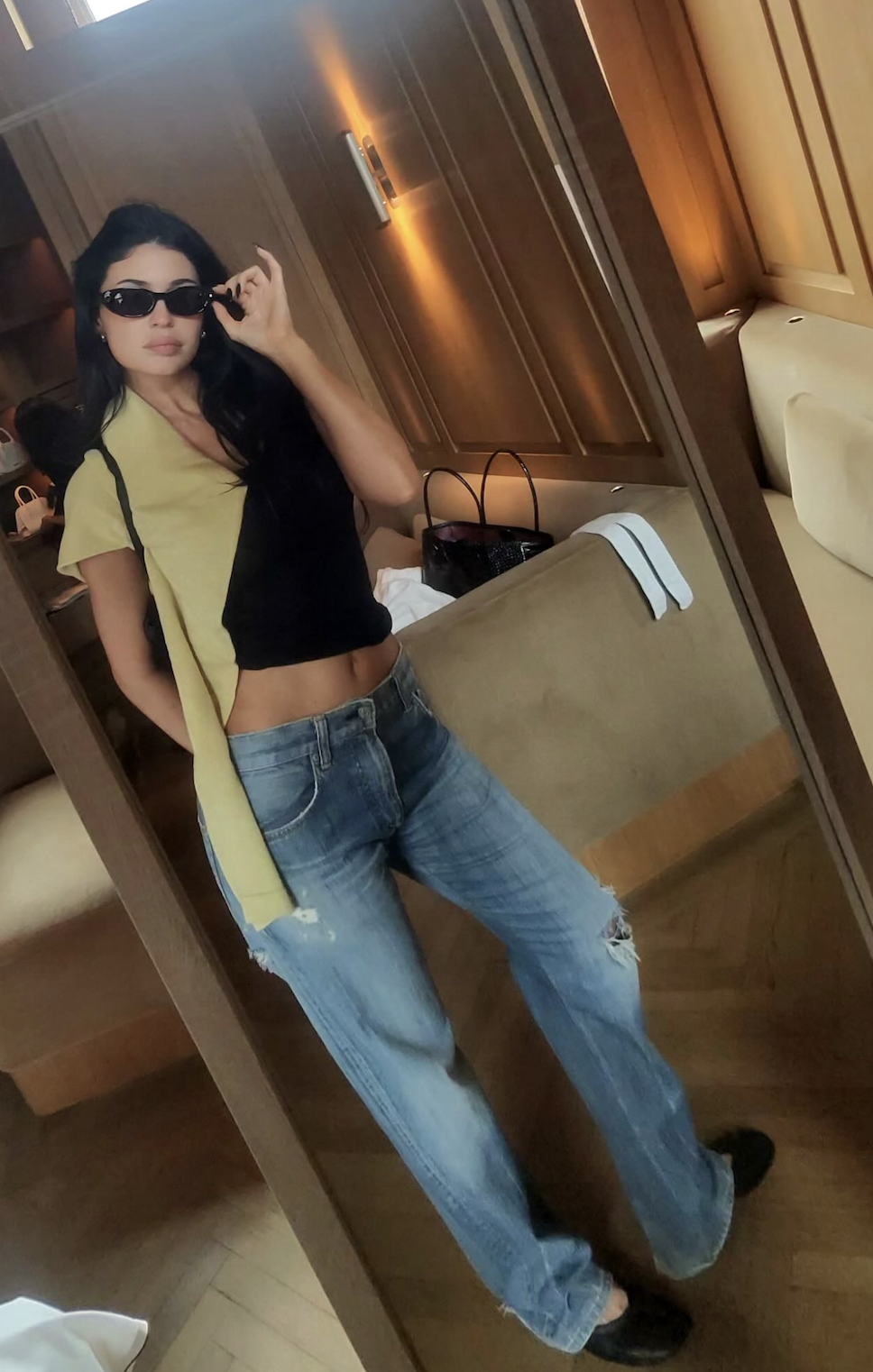 An image of kylie jenner wearing low rise jeans crop top outfit